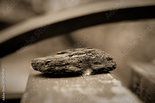 Brown wooden bark on wooden bench, close-up objects, defocused background