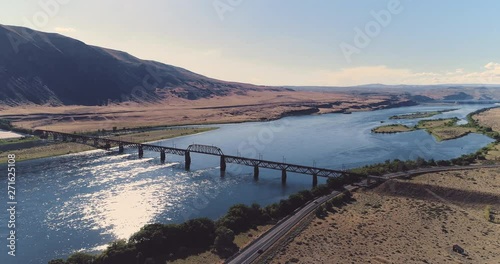 Wallpaper Mural A drone flyby shot of Beverly Bridge in front of its mountainous landscape, in Washington, USA, on a sunny day. The wide river sparkles under the sunlight. Torontodigital.ca