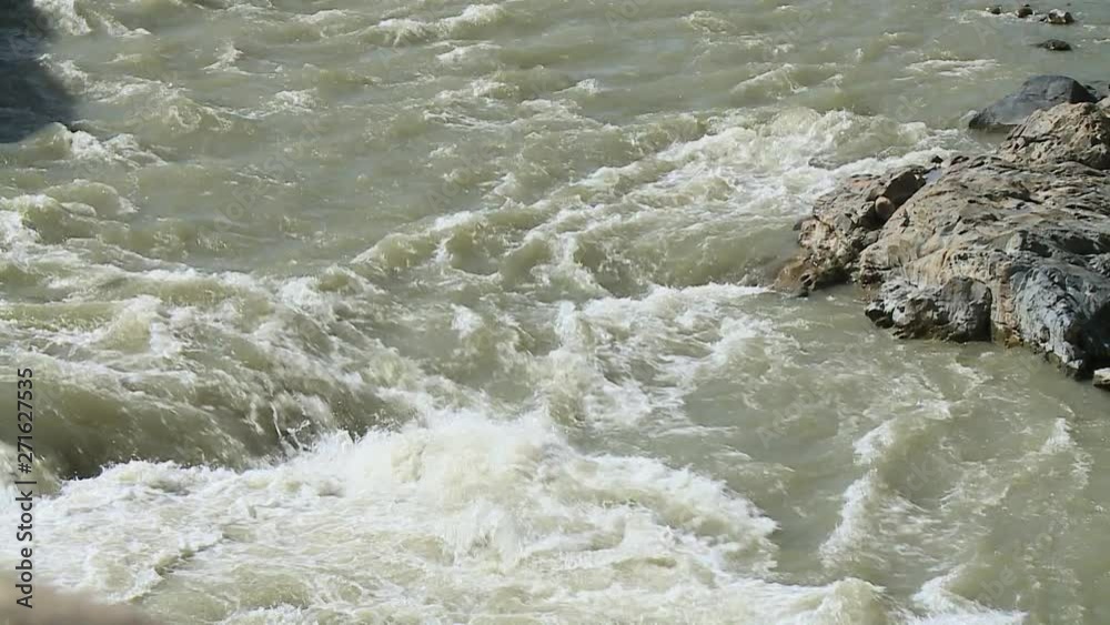 Extreme close-up high angle still shot of River Mapacho's dirty water splashing through rocks, Paucartambo, Peru Extreme close-up high angle still shot of River Mapacho's dirty water splashing through rocks, Paucartambo, Peru