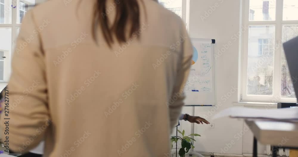 Fun happy multiethnic business people celebrate success together with excited African male boss riding office chair. Fun happy multiethnic business people celebrate success together with excited African male boss riding office chair.