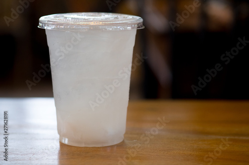 Cold water in plastic clear cup with lid