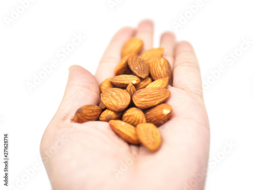almonds in hand on white background