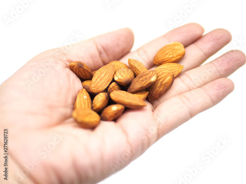 hand with almonds isolated on white background