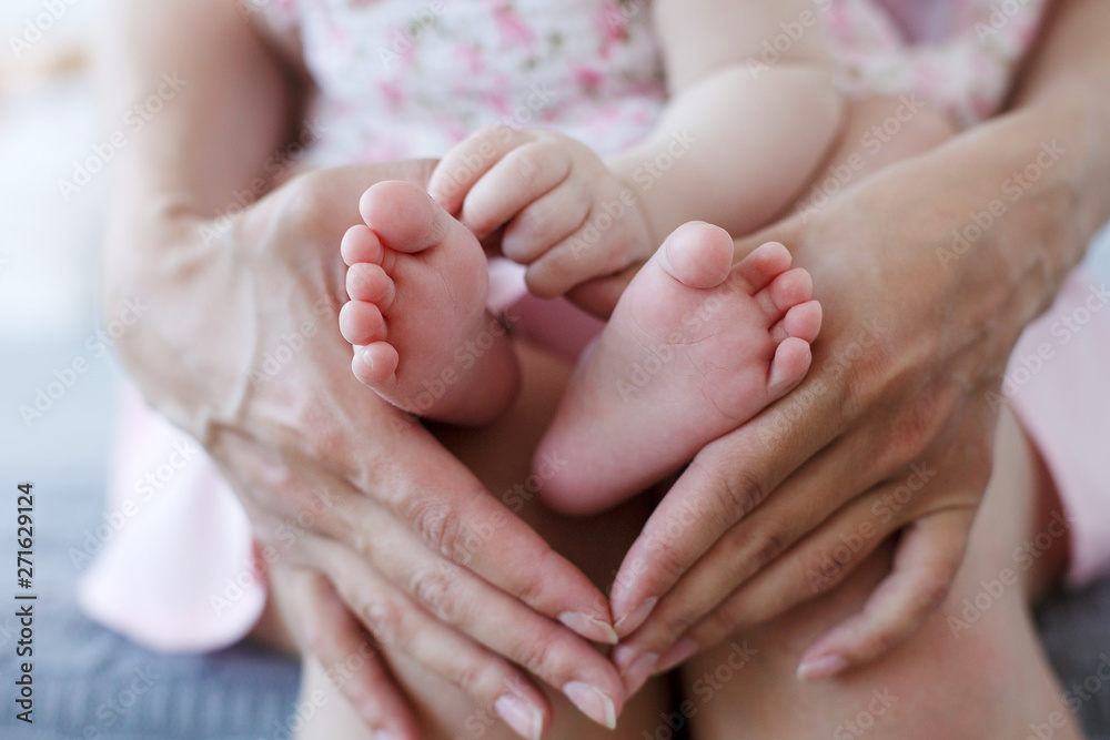 Small newborn baby legs in mothers lovely hand with soft focus on babie's foot.Newborn Babys feet. Small newborn baby legs in mothers lovely hand with soft focus on babie's foot Small newborn baby legs in mothers lovely hand with soft focus on babie's foot.Newborn Babys feet. Small newborn baby legs in mothers lovely hand with soft focus on babie's foot