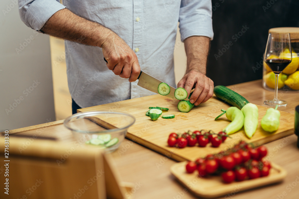 close up of man cutting vegetables for salad close up of man cutting vegetables for salad