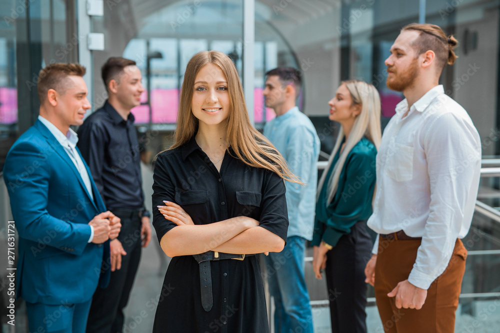 young beautiful woman on a background of colleagues in the office young beautiful woman on a background of colleagues in the office