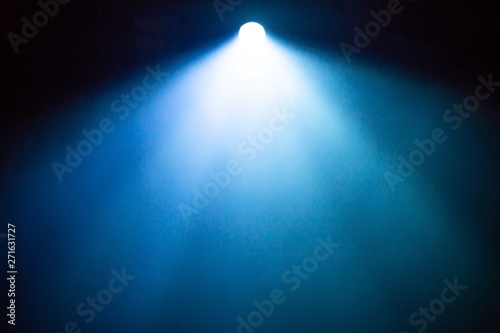 beautiful bright blue and white color wide lens projector with light beam for movie and cinema . smoke texture spotlight . screening for multimedia . black background in night party .