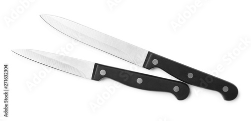 Stainless steel knives on white background, top view