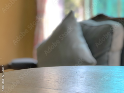 empty table with blurred pillow and window,interiors background.
