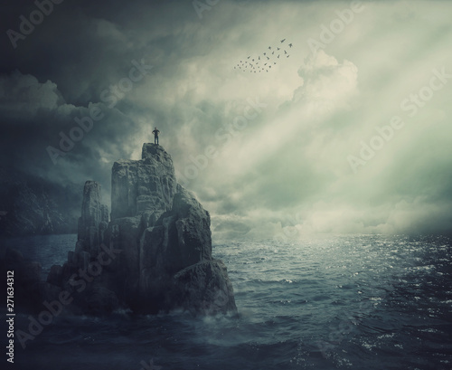 Obraz na plátne Surreal scene as man silhouette standing on the top of a cliff surrounded by the sea water