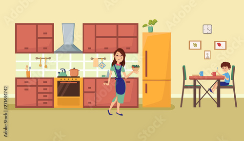 Woman holding plate with food. Boy sitting at the Dinner table. Kitchen interior with furniture and stove, cupboard, fridge, stove hood and utensils