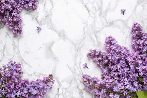 Lilac flowers on marble background with copyspace for text.Summer color and holiday concept.