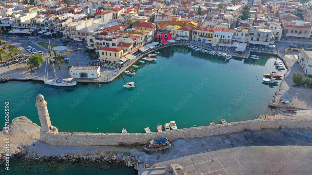 Fototapeta premium Aerial drone photo of unique old picturesque Venetian port with old lighthouse in the heart of famous city of Rethymno, Crete island, Greece