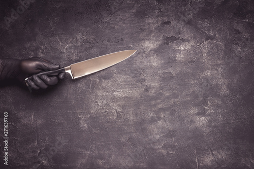 фотографія Male Hands with Black Latex Gloves and Knife on Dark Background
