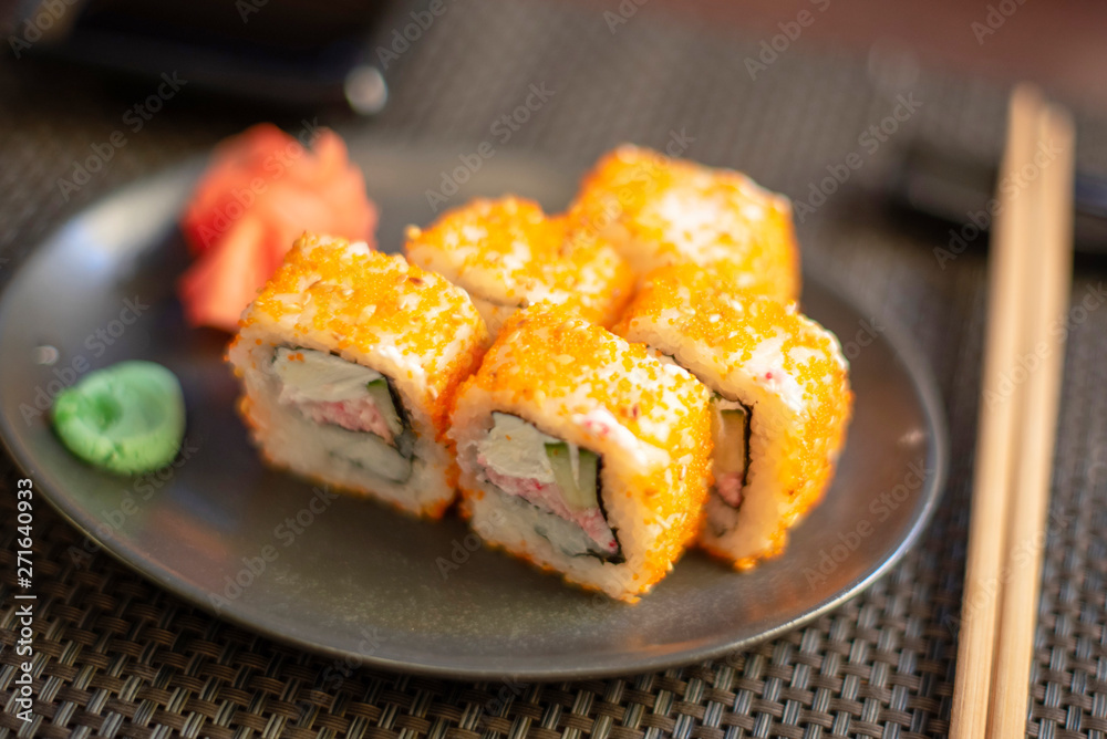 set of California rolls on dark background set of California rolls on dark background