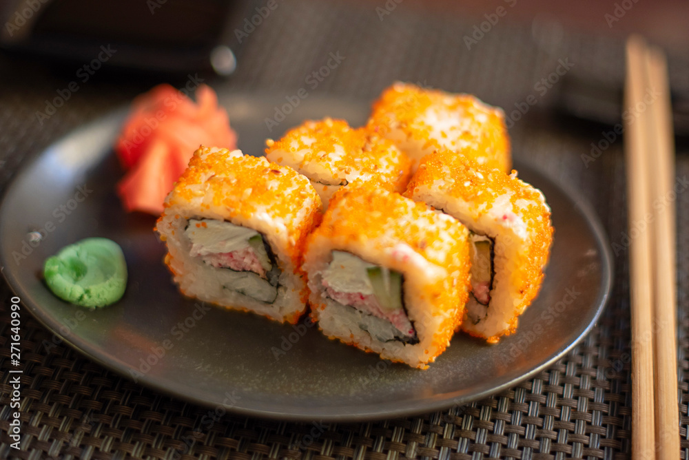 set of California rolls on dark background