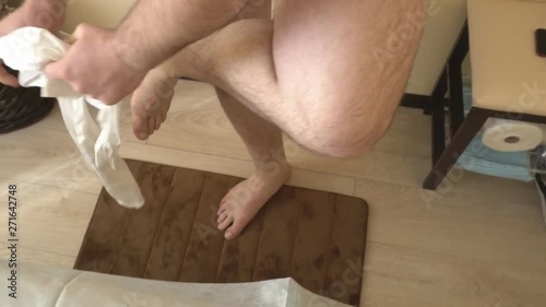 A man wears special clothes in a beauty salon to undergo a modern procedure LPG massage to reduce excess weight, clothe oneself