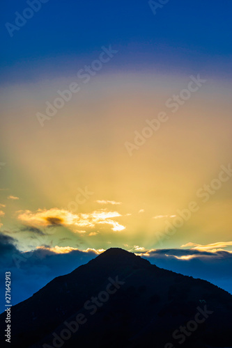 Sunrise over Mountain Peak with Rays of Light © Mark