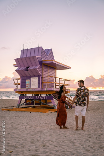 Miami south Beach, youn couple men and woman on the beach during sunrise. Miami beach Floarida © Fokke Baarssen