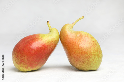 Ugly vegetables , two ripe pears of bizarre shape ,are leaning .  on a white background .