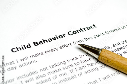 Child behavior contract with wooden pen