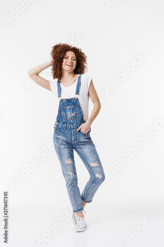 Full length of a cheerful young redhead curly girl