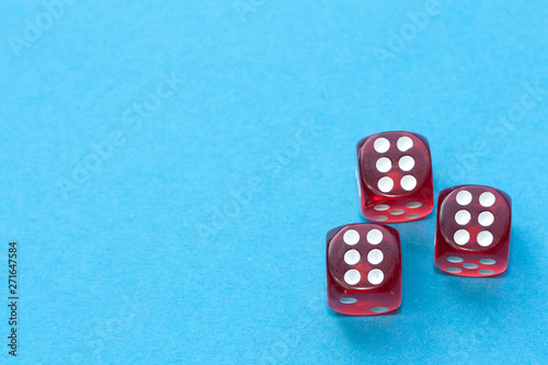 Red dices on blue background.