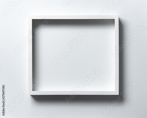 Empty white wood frame with shadow on white background
