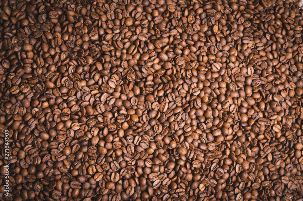 High resolution top view close up macro photo of look delicious dark roasted coffee beans, Flash light reflecting on the surface of the coffee beans make it look shinny beautiful and be nice for eat. High resolution top view close up macro photo of look delicious dark roasted coffee beans, Flash light reflecting on the surface of the coffee beans make it look shinny beautiful and be nice for eat.