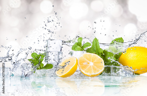 ice cubes, mint leaves with lemons isolated on a white background photo