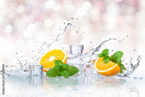 ice cubes, mint leaves with oranges isolated on a white background photo
