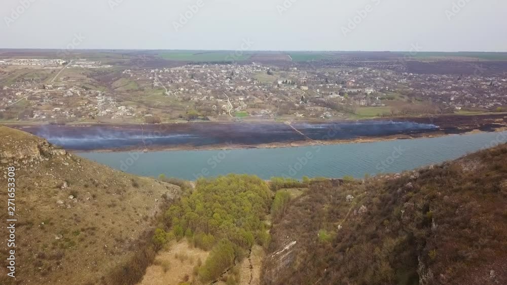 Arial view over the river and small village. Spring fires. Dniester river of Moldova republic. Arial view over the river and small village. Spring fires. Dniester river of Moldova republic.