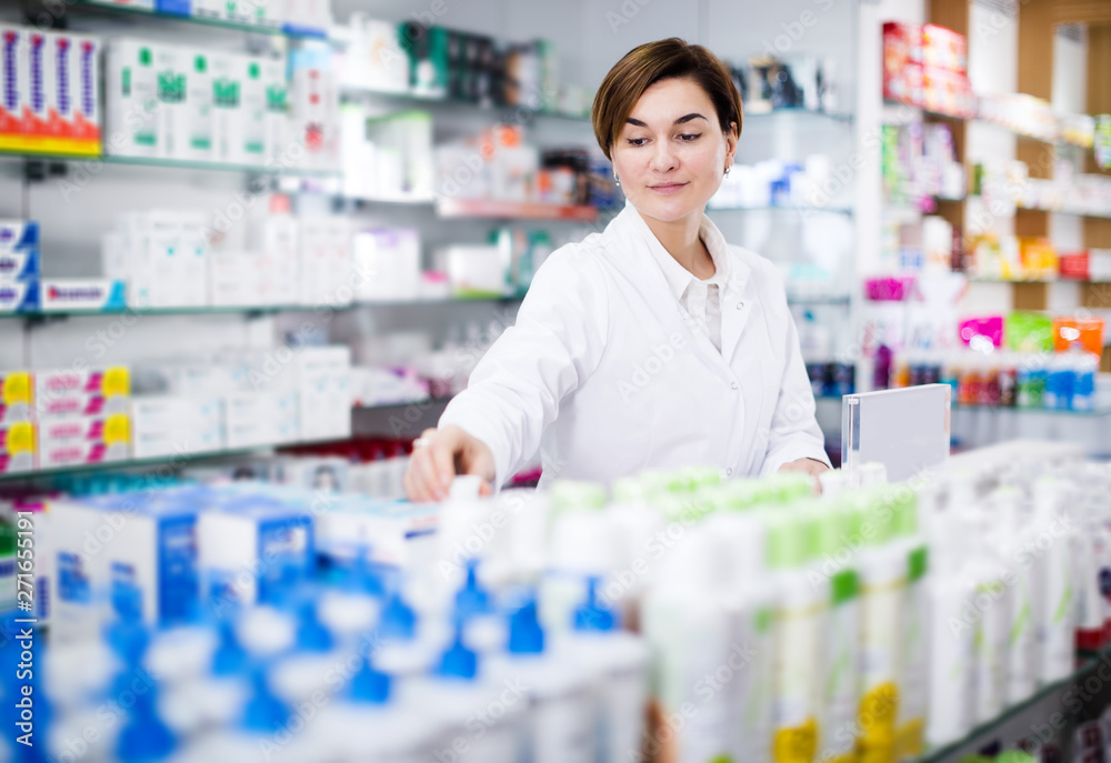 Pharmacist organizing assortment of care products