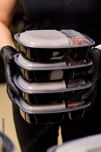 Lunch box with food in the hands. Catering
