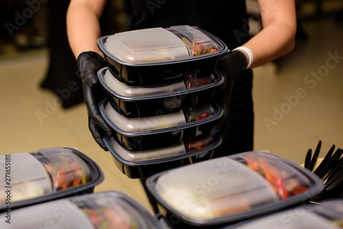 Lunch box with food in the hands. Catering photo