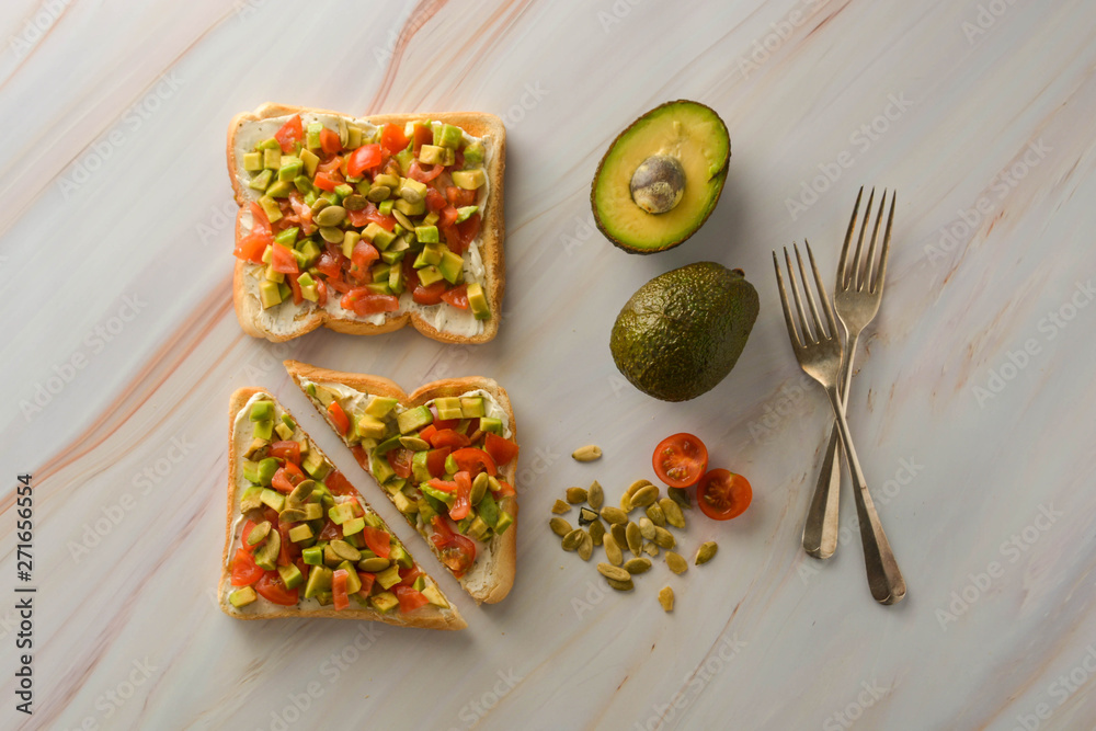 Toast with cream cheese, avocado and cherry tomatoes. Healthy food. Copy space.