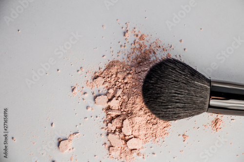 cosmetic powder slide and black makeup brush