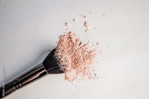 cosmetic powder slide and black makeup brush