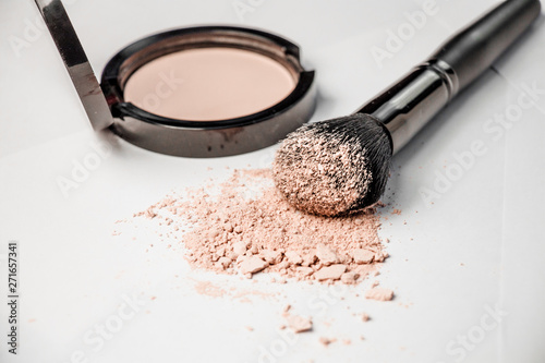 open powder box, black make-up brush, powder hill