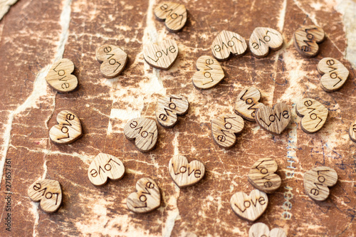 Many wooden hearts with the inscription love. wooden hearts with the inscription love. hearts with the inscription love. Small figurines of hearts