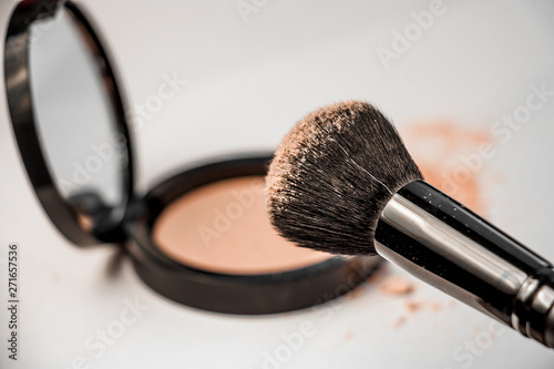 open powder box, black make-up brush, powder hill