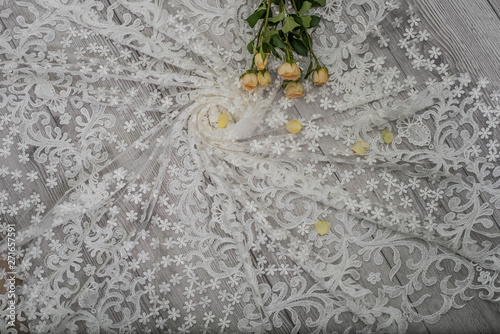 The texture of lace on wooden background decoreted roses. photo