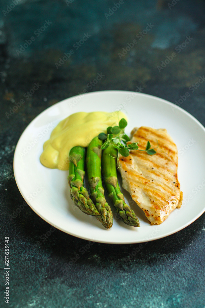 asparagus and chicken breast fillets grill, hollandaise sauce. food background. top
