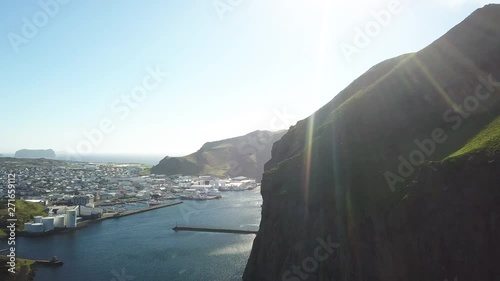 Sun shines over coastal town of Vestmannaeyjar, aerial