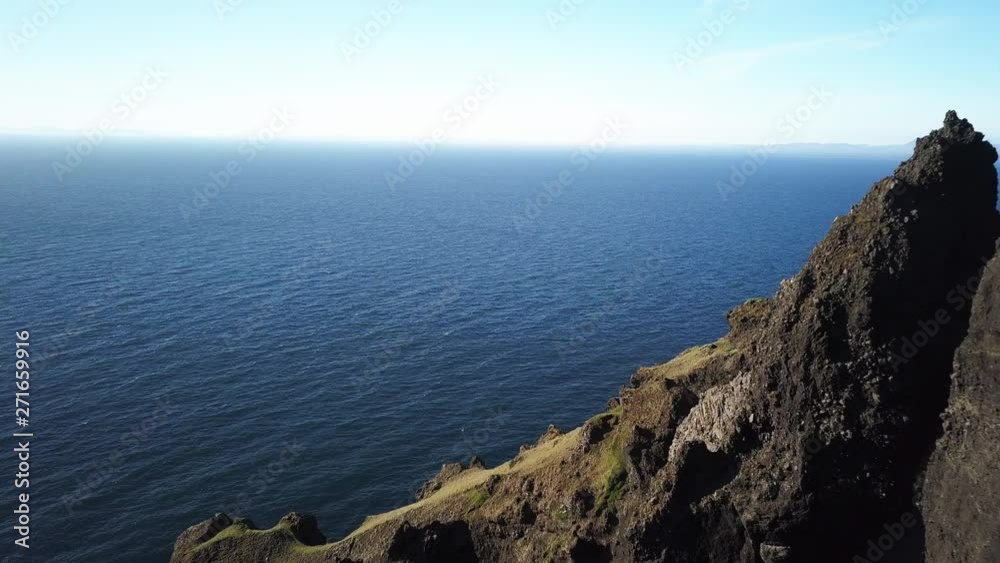 Bird flies over mountain coast in Iceland, aerial Bird flies over mountain coast in Iceland, aerial