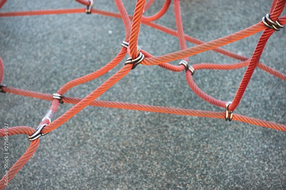 Red ropes connected by reef metal knot Red ropes connected by reef metal knot