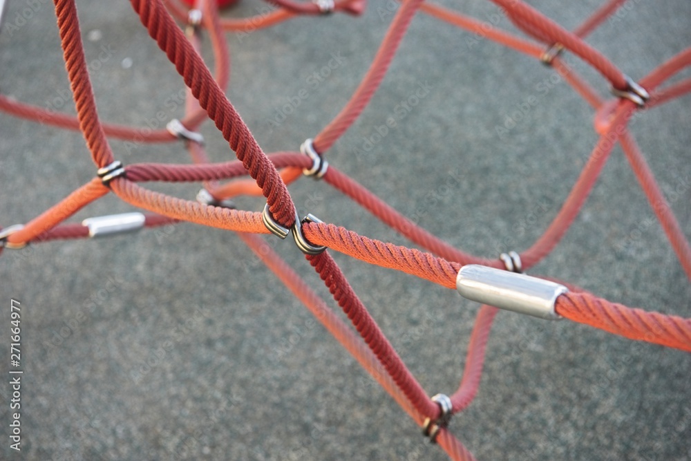 Red ropes connected by reef metal knot