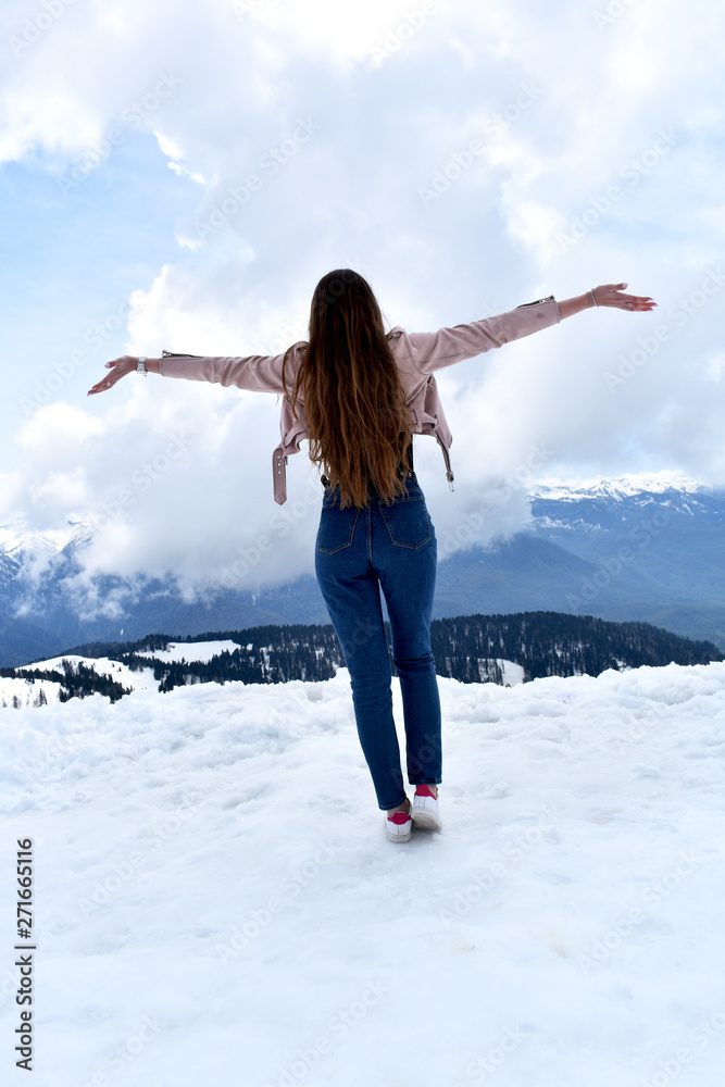 Beautiful girl in the snowy mountains with long wavy hair Beautiful girl in the snowy mountains with long wavy hair