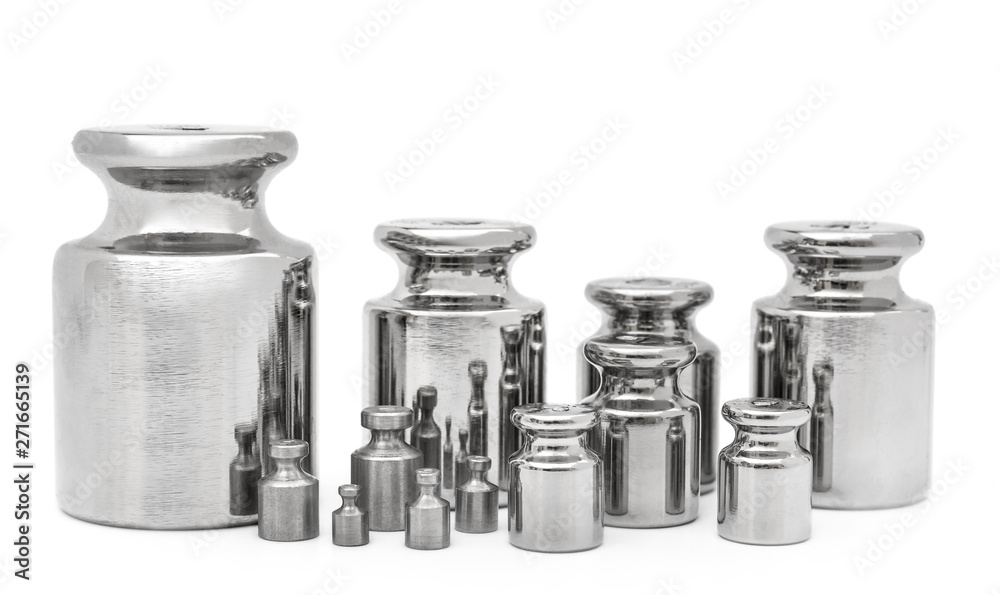 Set of weights for laboratory scales on white. Set of weights for laboratory scales on white.