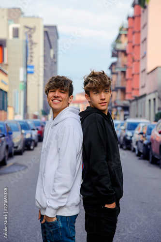 Two best friends, posing in the middle of the street in Milan. 